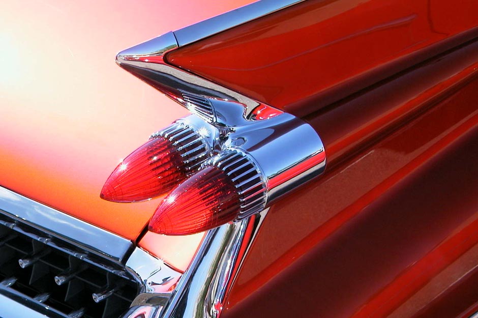 AUTOMOTIVE Exterior - Form, color and composition study of a beautifully restored '58 Candy Apple Red Cadillac. Enhanced specular highlights. Removed unwanted reflections. Image used in automotive publication.